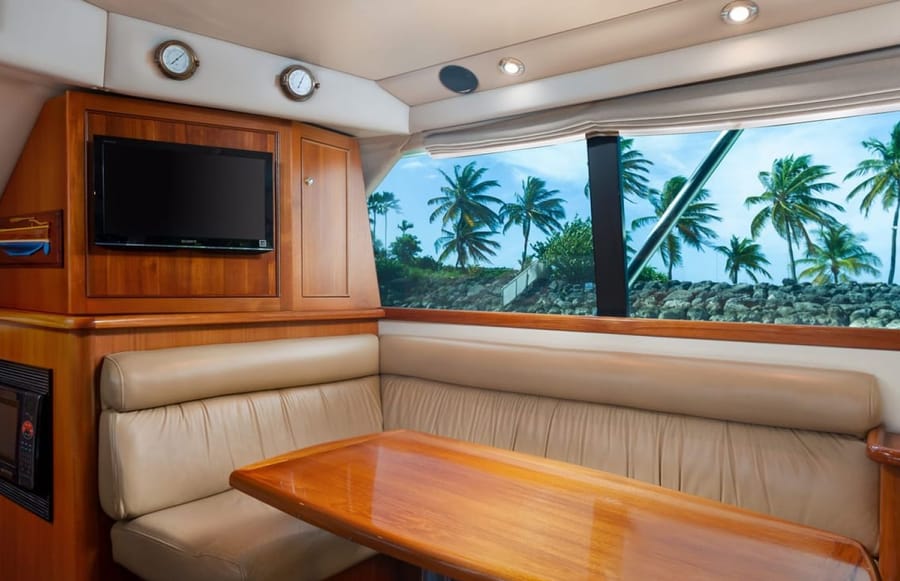 The air-conditioned cabin: a cushioned settee and a teak table