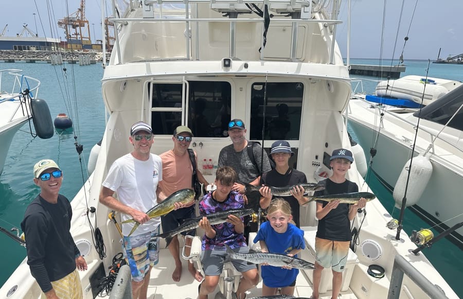A family with their catch of mahi mahi and barracuda in the cockpit