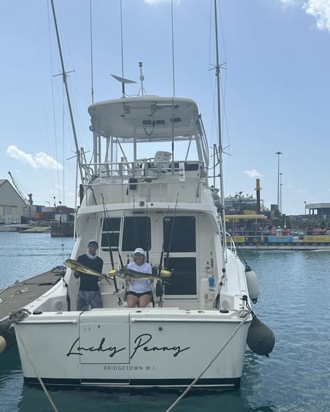 The stern of the boat at the dock, her name Lucky Penny, Bridgetown W.I. on the transom